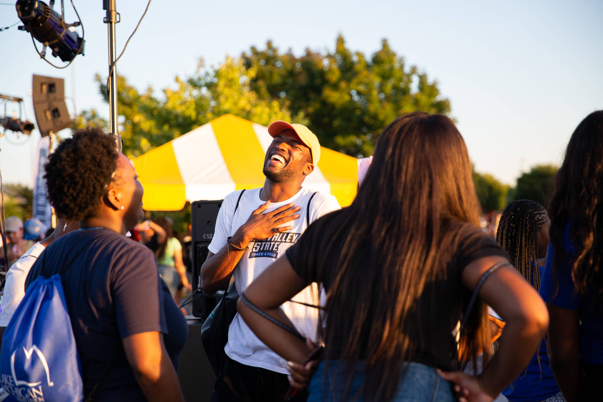 A student laughs while visiting the outdoor Campus Life night hosted on GVSU's Allendale Campus on September 4, 2018.